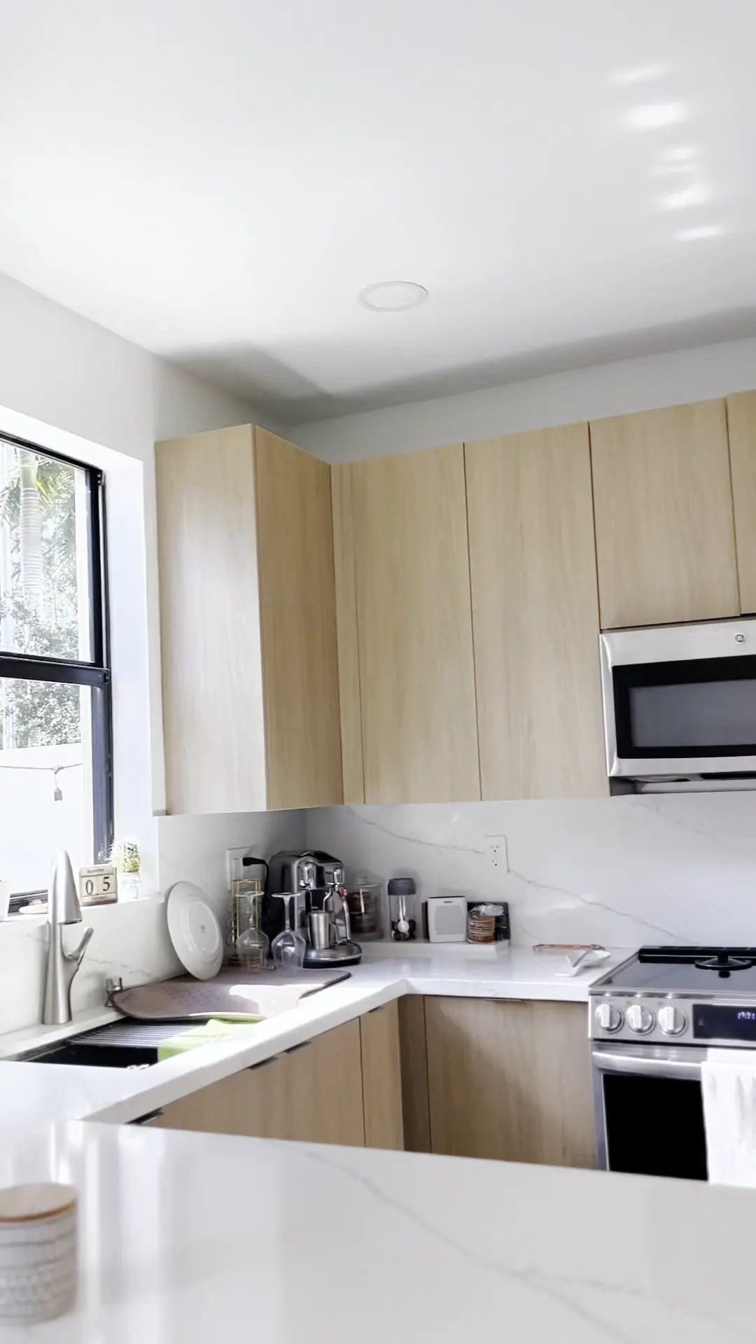 White countertop run with light wood upper cabinets