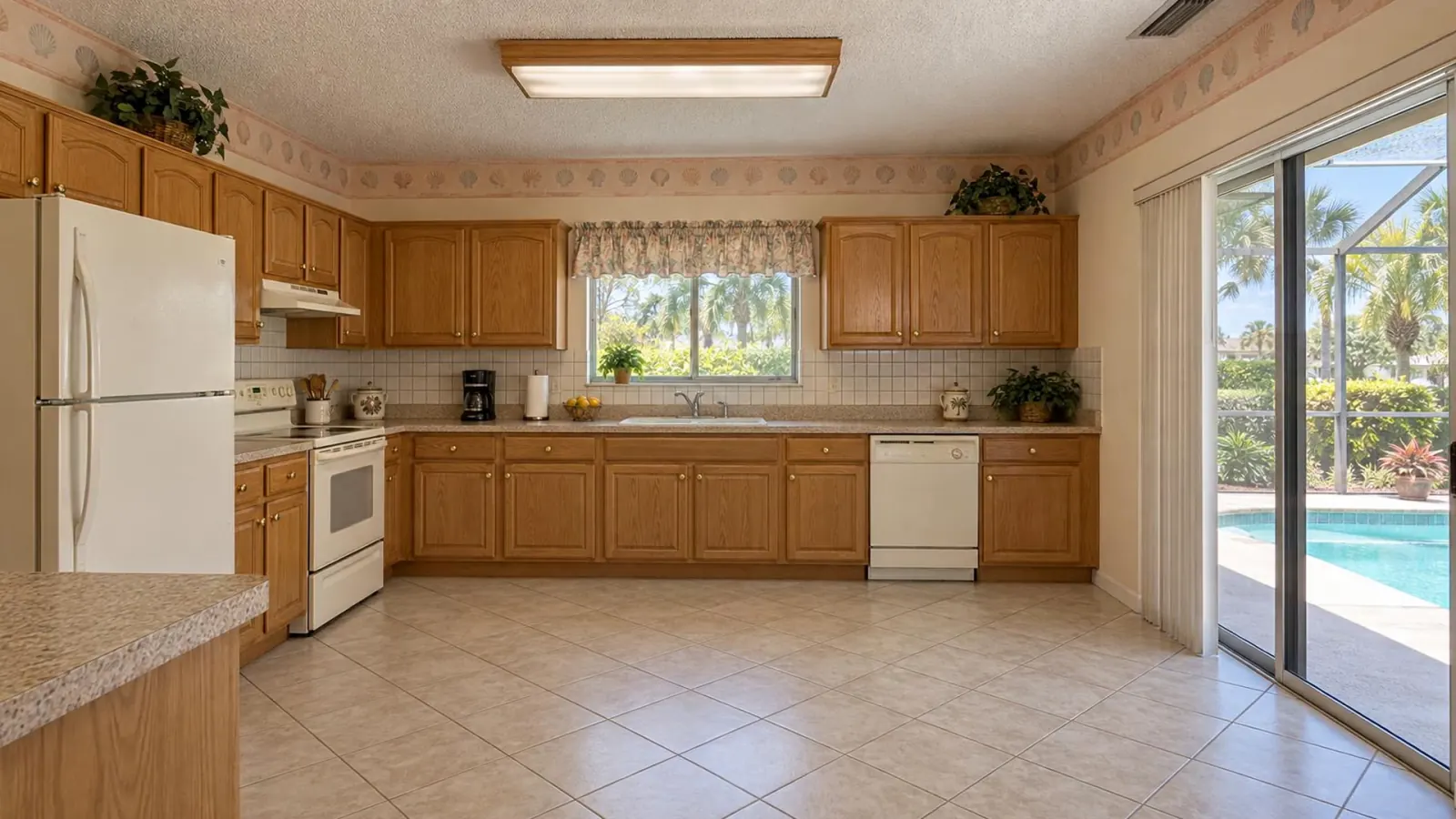 Illustration: a dated 1990s Florida kitchen with oak cabinets, laminate counters and a seashell wallpaper border